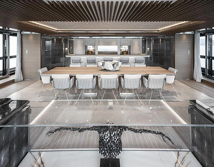 a large room with a table and chairs aboard ATTILA Yacht for Sale