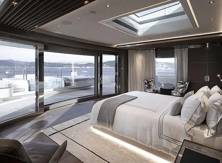a room with a bed and a large window aboard ATTILA Yacht for Sale