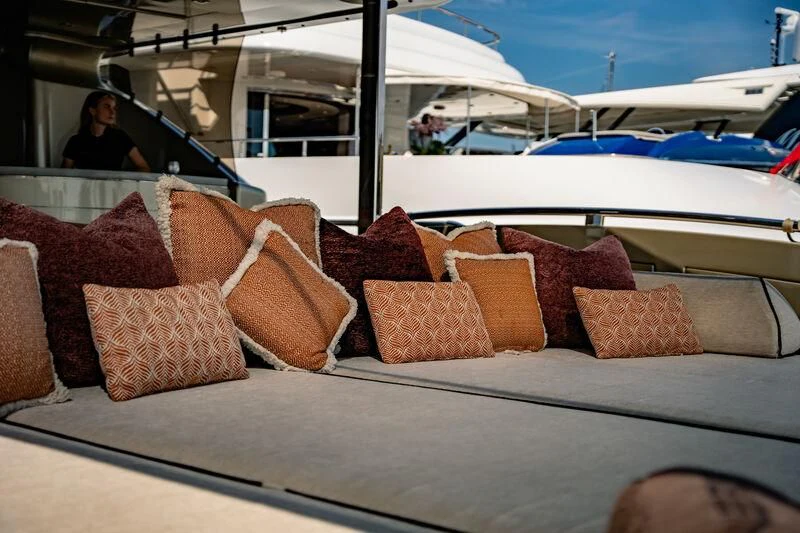 a couch with pillows on it aboard GENESIS Yacht for Sale