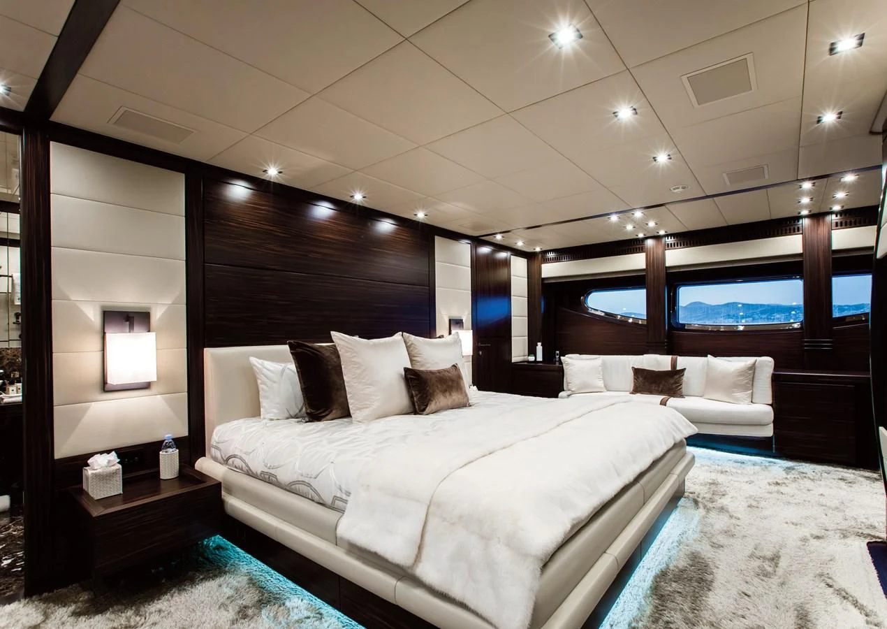 a room with a bed and a television aboard GENESIS Yacht for Sale