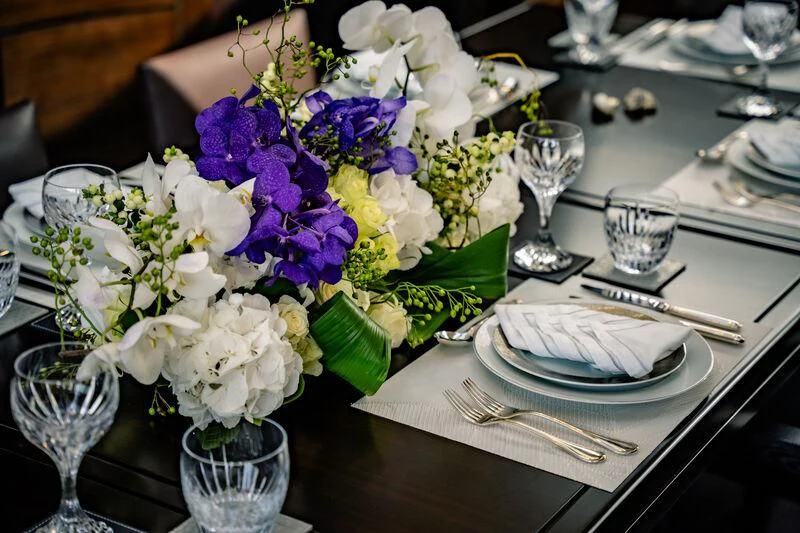 a table with flowers and plates aboard GENESIS Yacht for Sale
