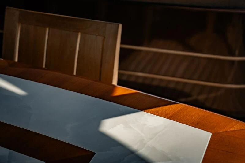 a white piece of paper on a wooden surface aboard GENESIS Yacht for Sale