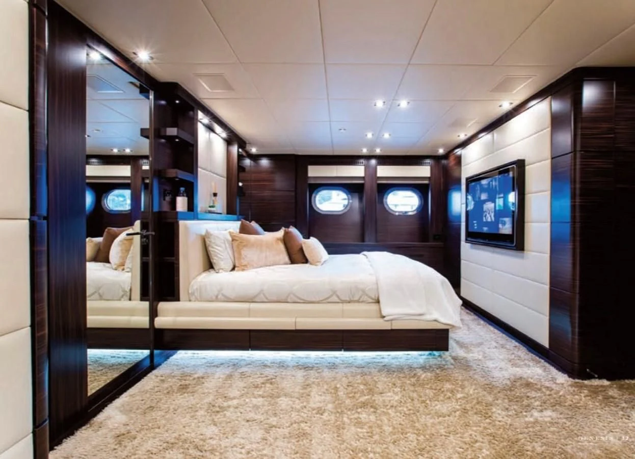 a room with a bed and a tv on the wall aboard GENESIS Yacht for Sale