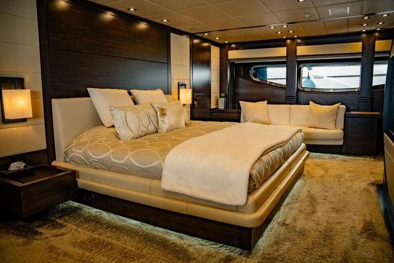 a room with a bed and a window aboard GENESIS Yacht for Sale