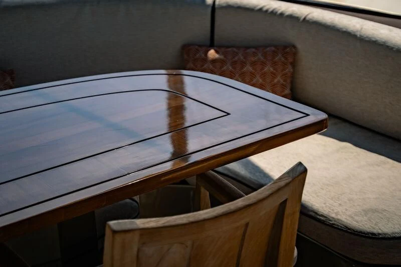 a wooden chair next to a window aboard GENESIS Yacht for Sale