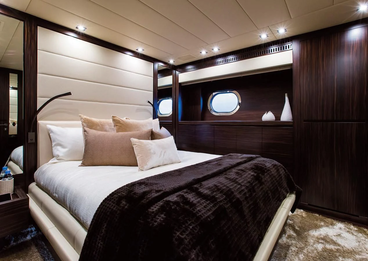 a bed with a white bed spread aboard GENESIS Yacht for Sale
