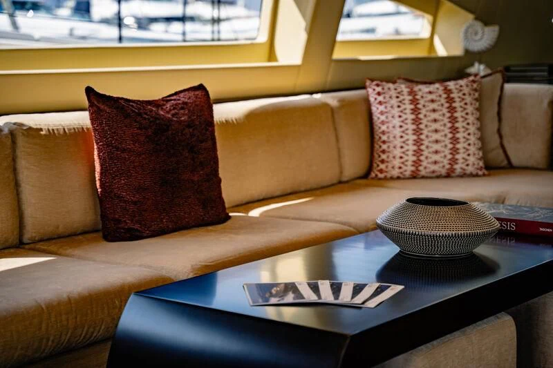a coffee table with pillows on it aboard GENESIS Yacht for Sale