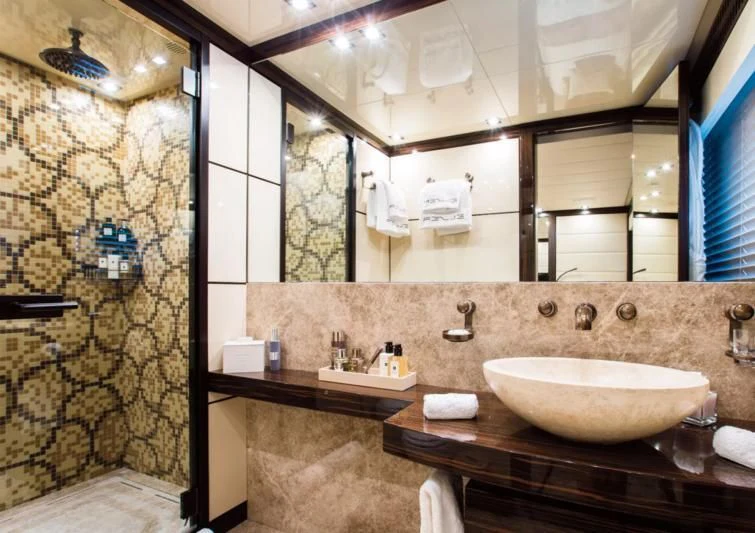 a bathroom with a large mirror aboard GENESIS Yacht for Sale