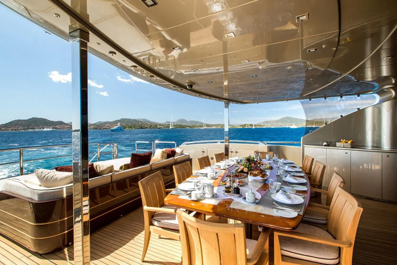 a table set for a meal on a deck overlooking the ocean aboard GENESIS Yacht for Sale