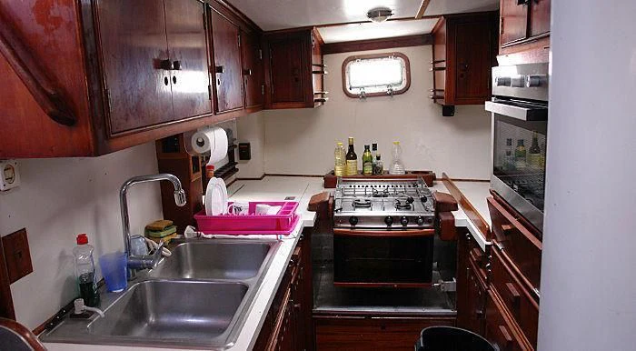 a kitchen with wooden cabinets aboard WHITE EAGLE Yacht for Sale