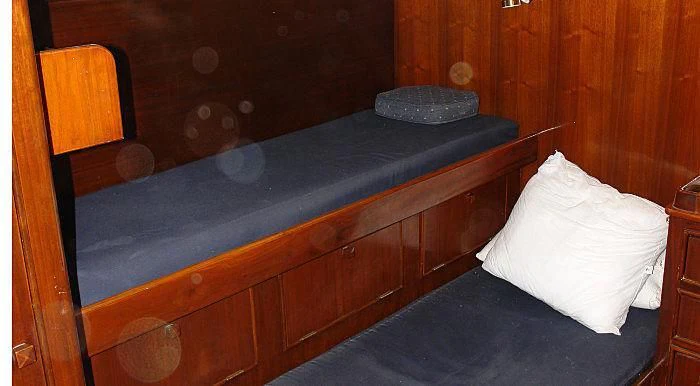 a bed with a wooden headboard aboard WHITE EAGLE Yacht for Sale