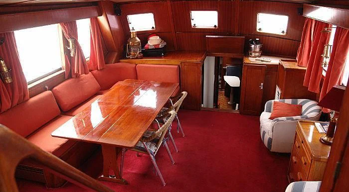 a living room with a table and chairs aboard WHITE EAGLE Yacht for Sale