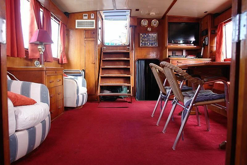 a living room with a red carpet aboard WHITE EAGLE Yacht for Sale