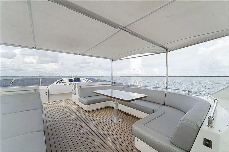 a room with a table and a bed aboard ADAMO Yacht for Sale