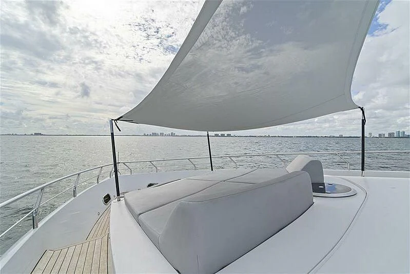 a white boat on a body of water aboard ADAMO Yacht for Sale