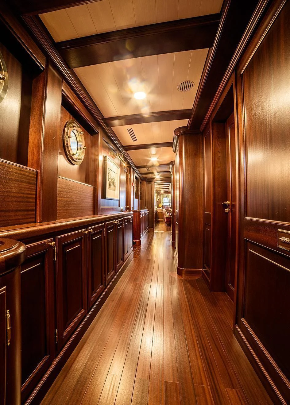 a wood hallway with wood cabinets aboard TARANSAY Yacht for Sale