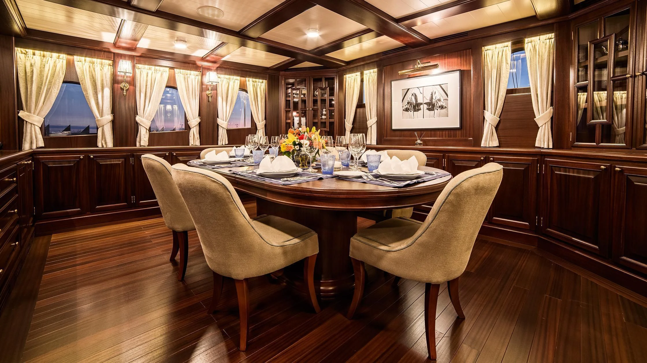 a large dining table in a large room with a large window aboard TARANSAY Yacht for Sale