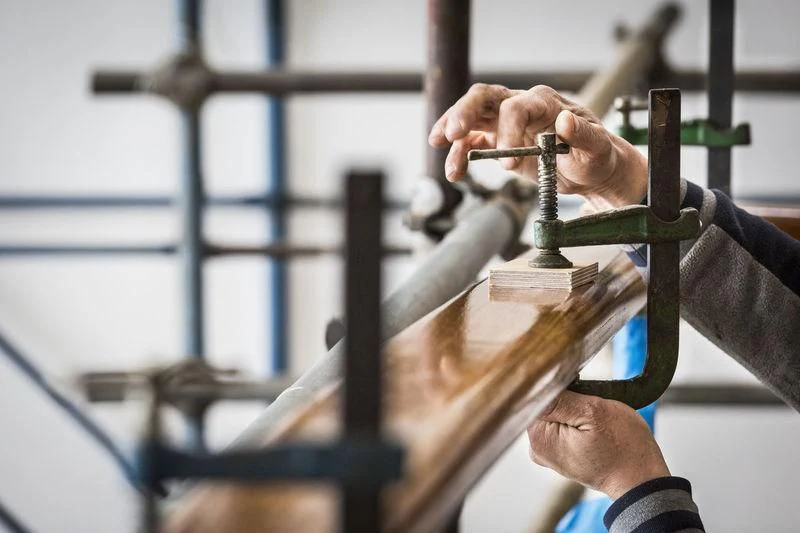 close-up of hands holding a rope aboard TARANSAY Yacht for Sale