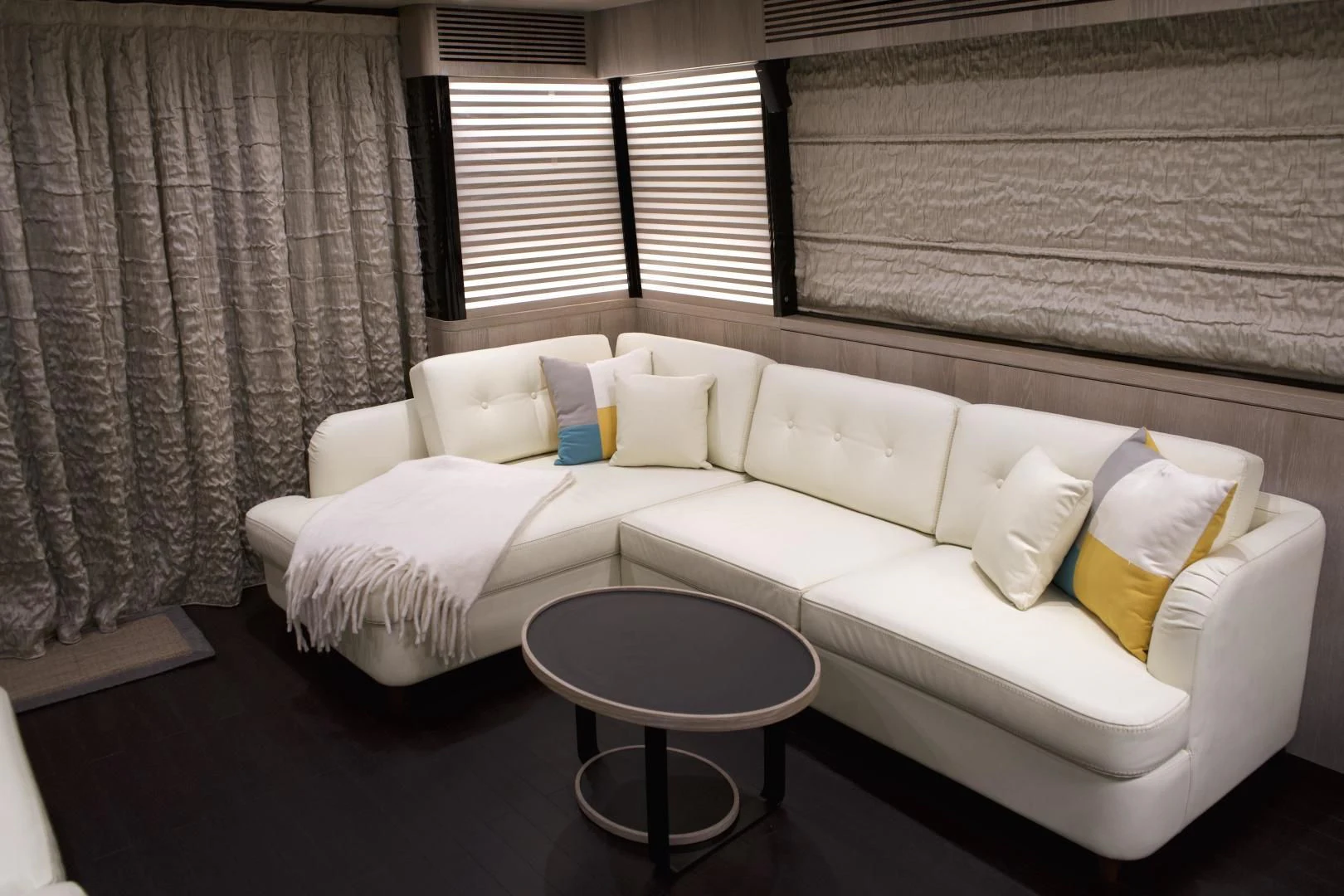 a white couch with pillows aboard RAINBOW GODDESS Yacht for Sale