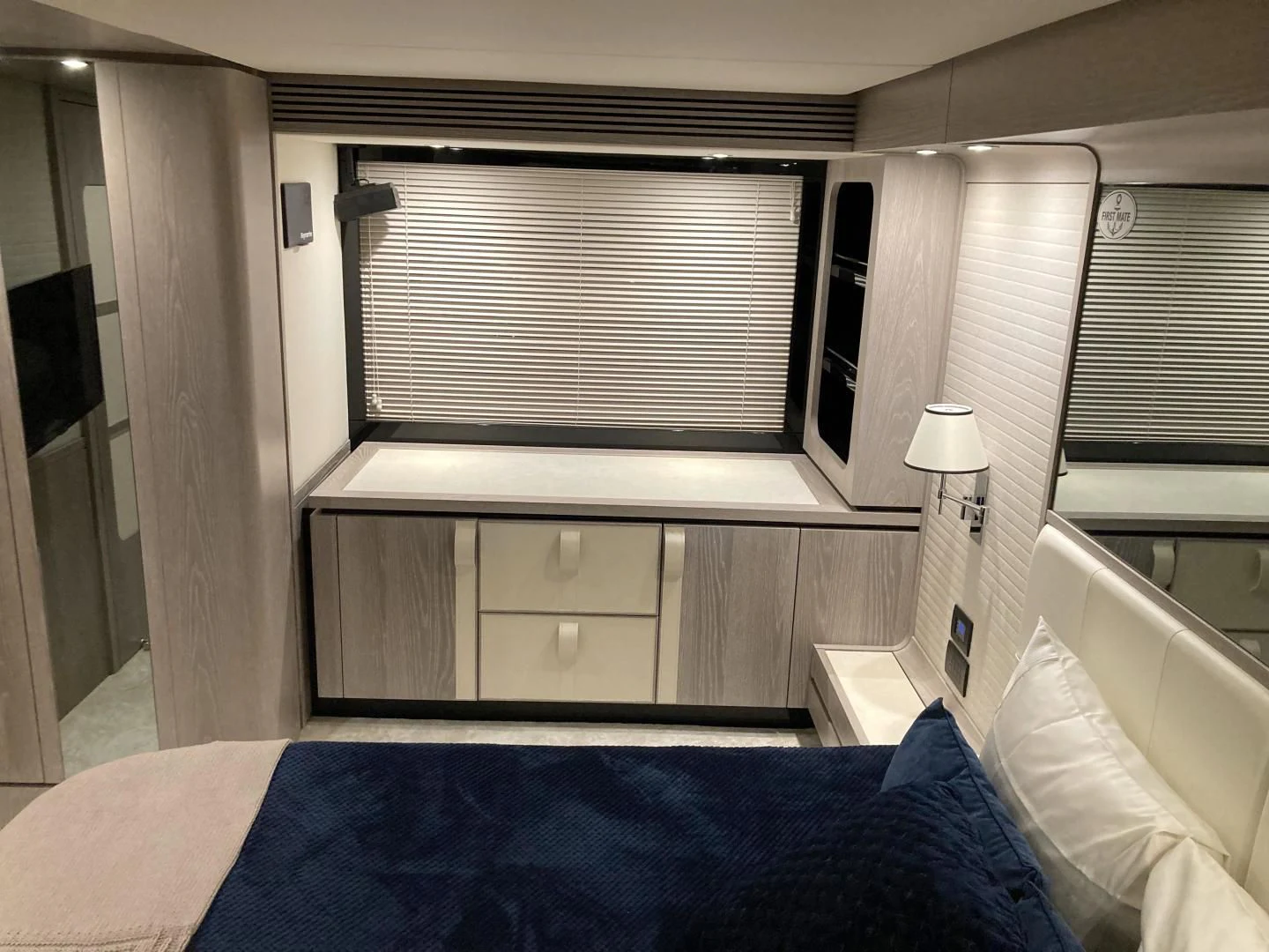 a bedroom with a bed and a window aboard RAINBOW GODDESS Yacht for Sale