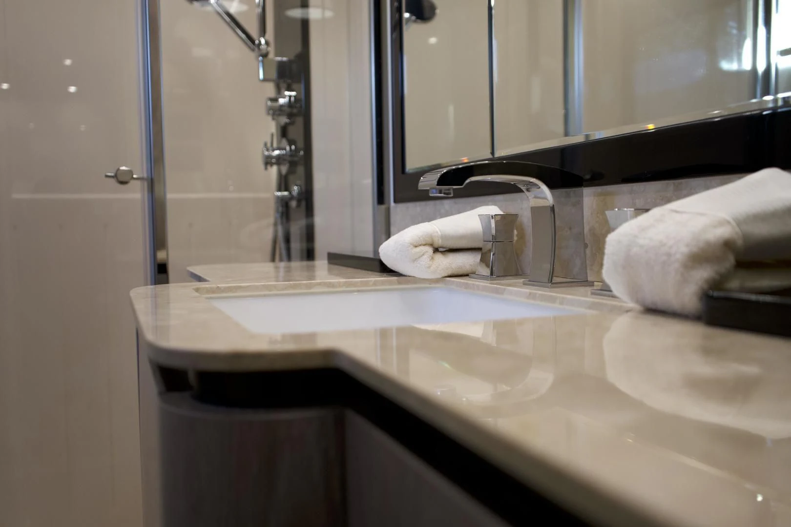 a bathroom sink with towels aboard RAINBOW GODDESS Yacht for Sale