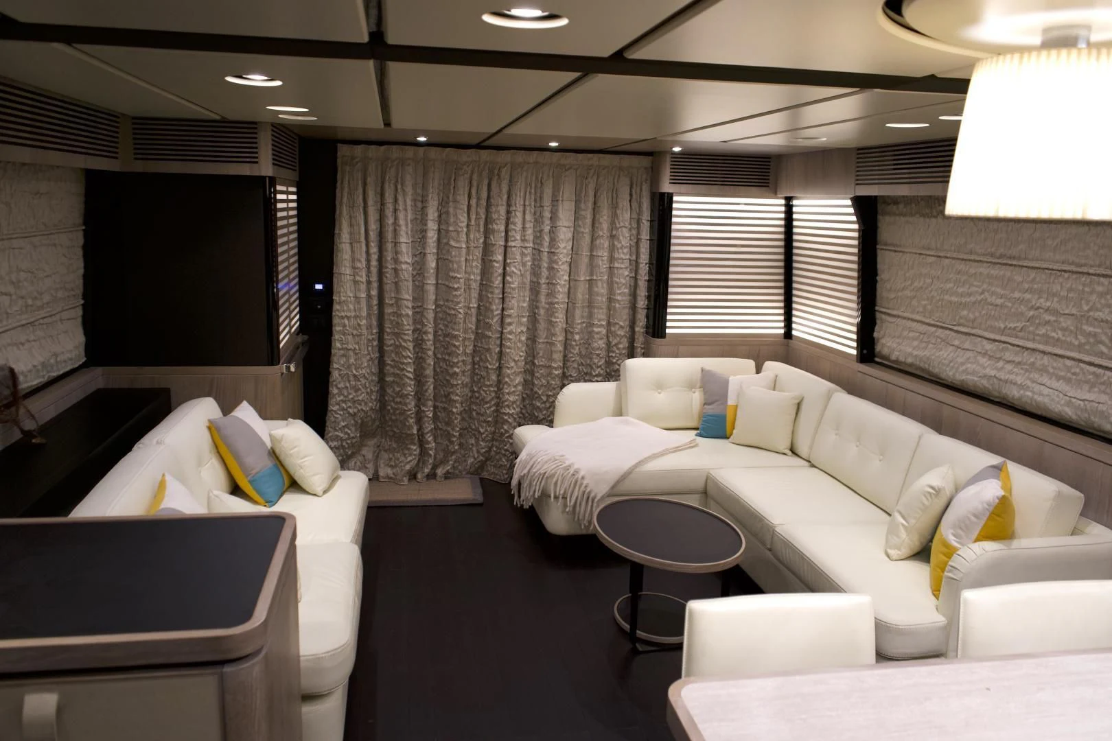 a room with couches and a table aboard RAINBOW GODDESS Yacht for Sale