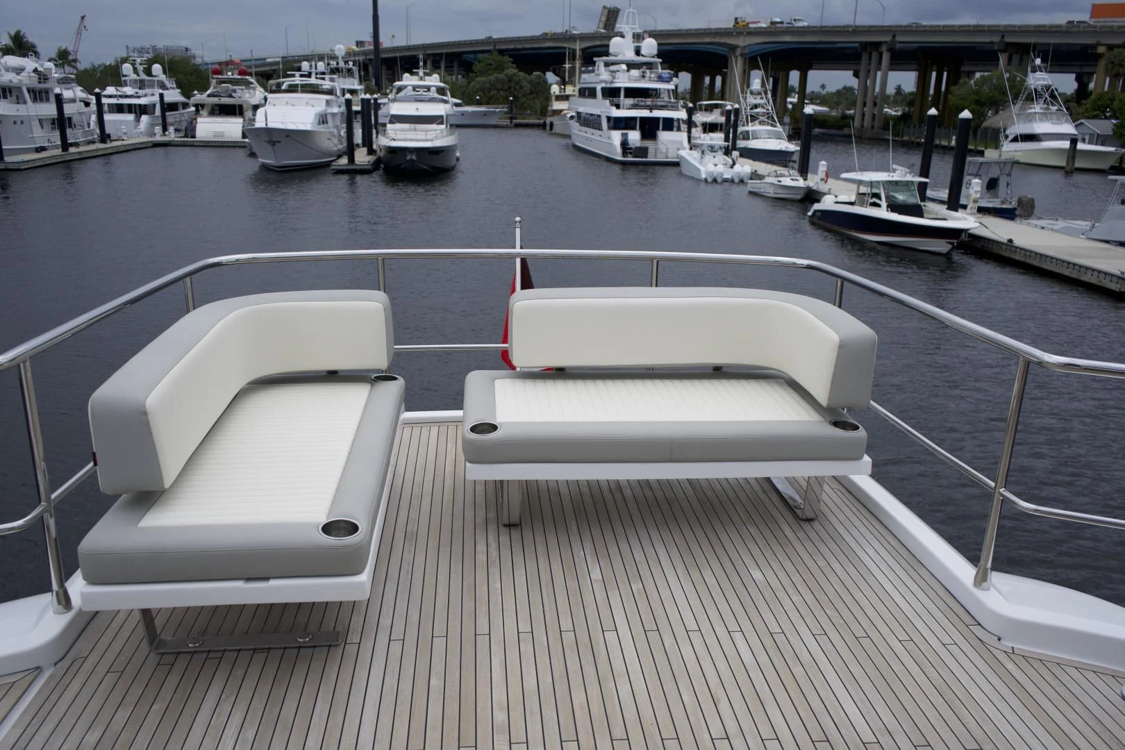 a white lounge chair on a dock aboard RAINBOW GODDESS Yacht for Sale