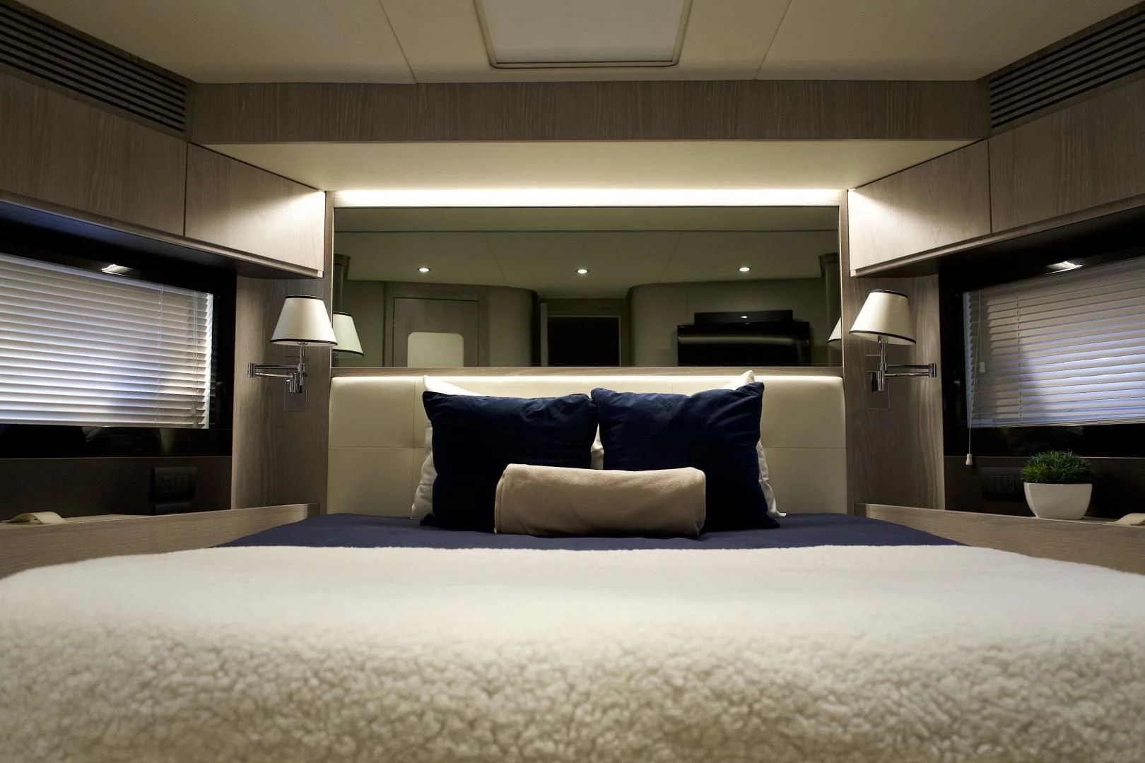 a bed with a white bed spread aboard RAINBOW GODDESS Yacht for Sale