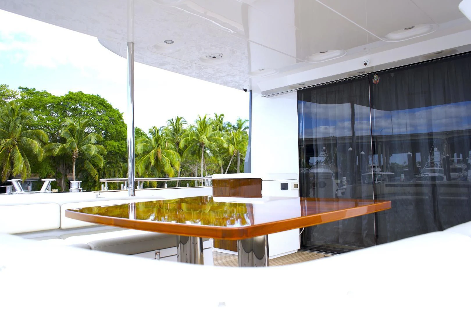 a table with a wood railing aboard RAINBOW GODDESS Yacht for Sale
