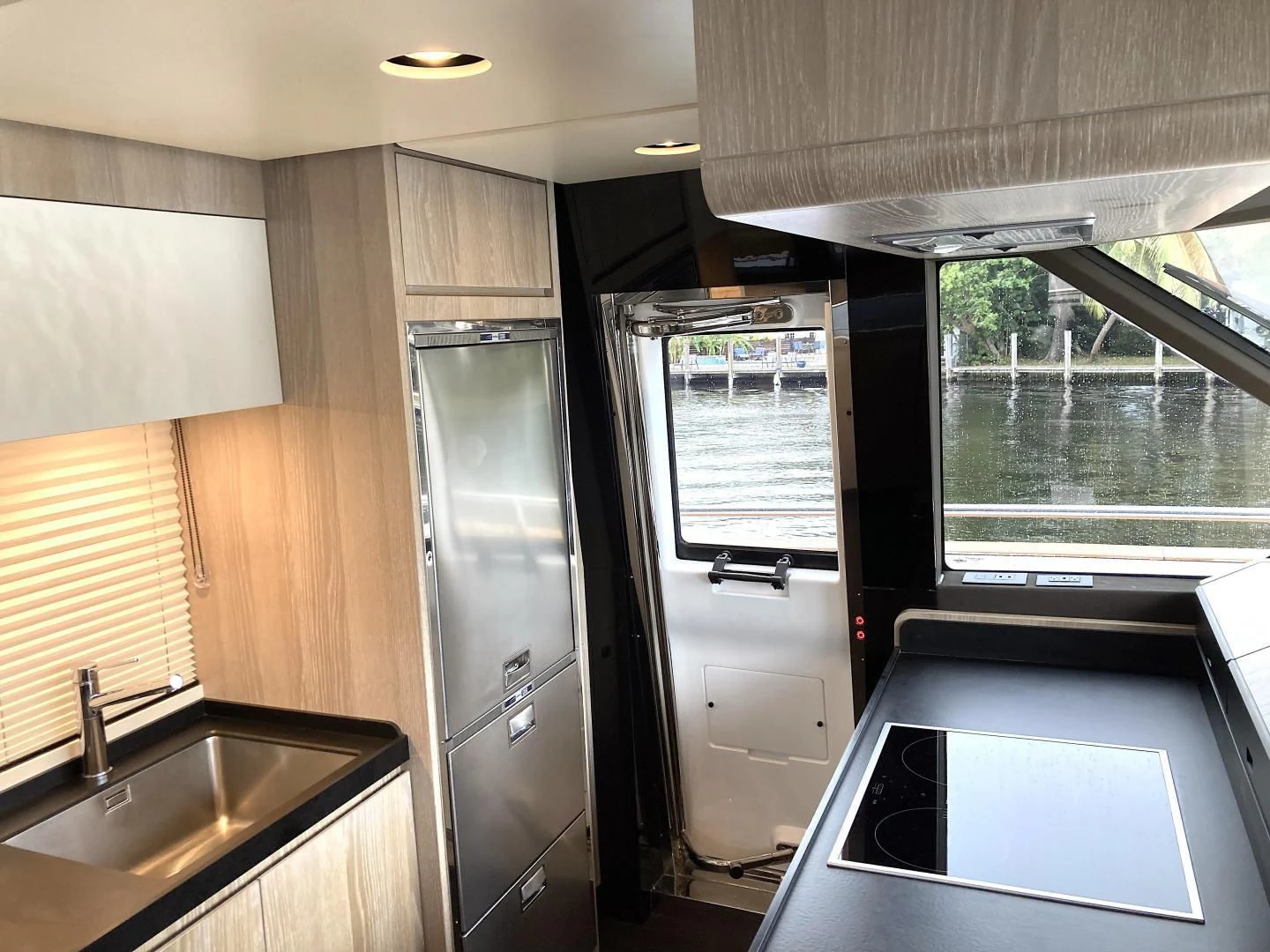 a kitchen with a sink and a refrigerator aboard RAINBOW GODDESS Yacht for Sale