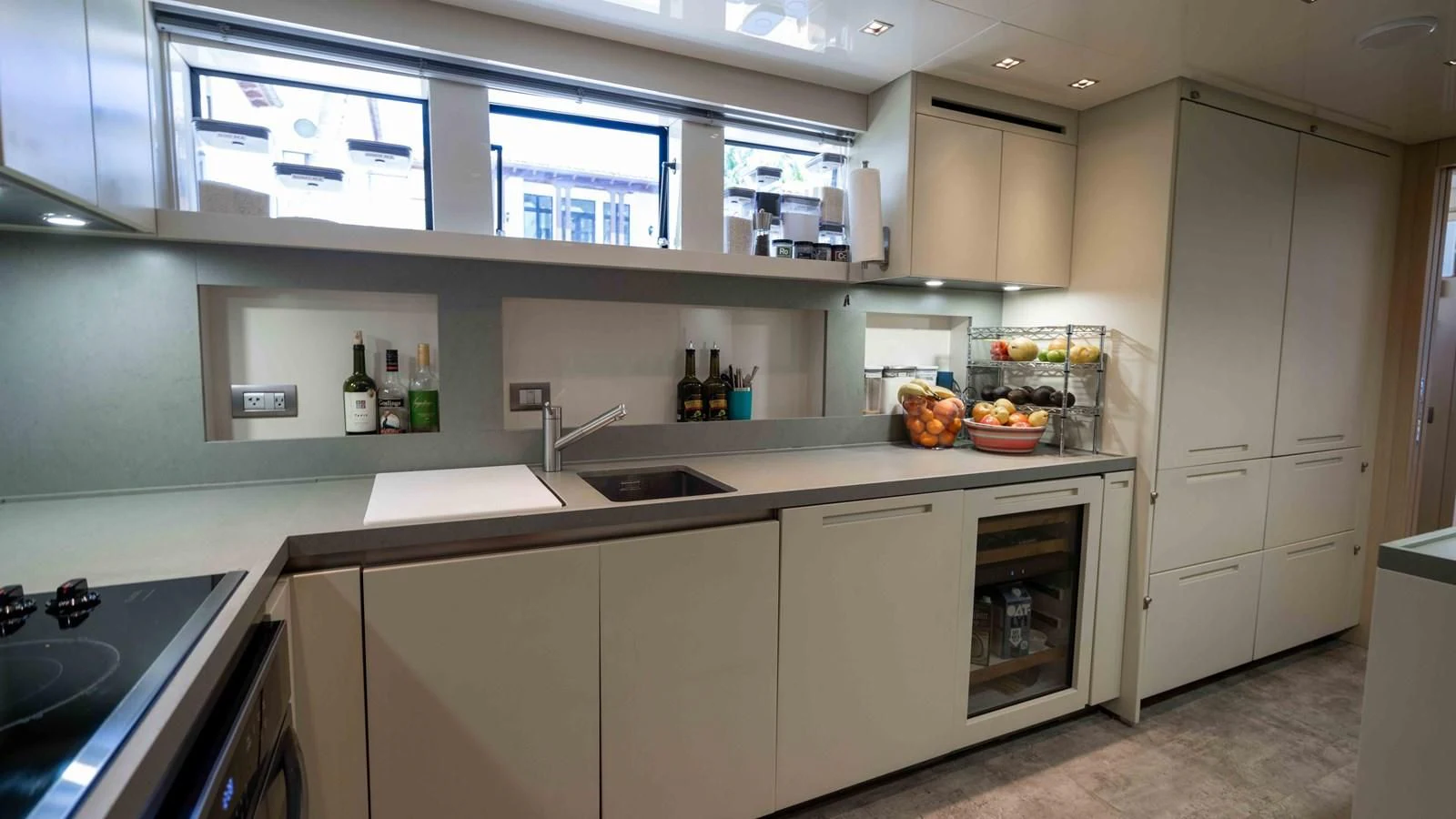 a kitchen with white cabinets aboard 106 FLYBRIDGE Yacht for Sale