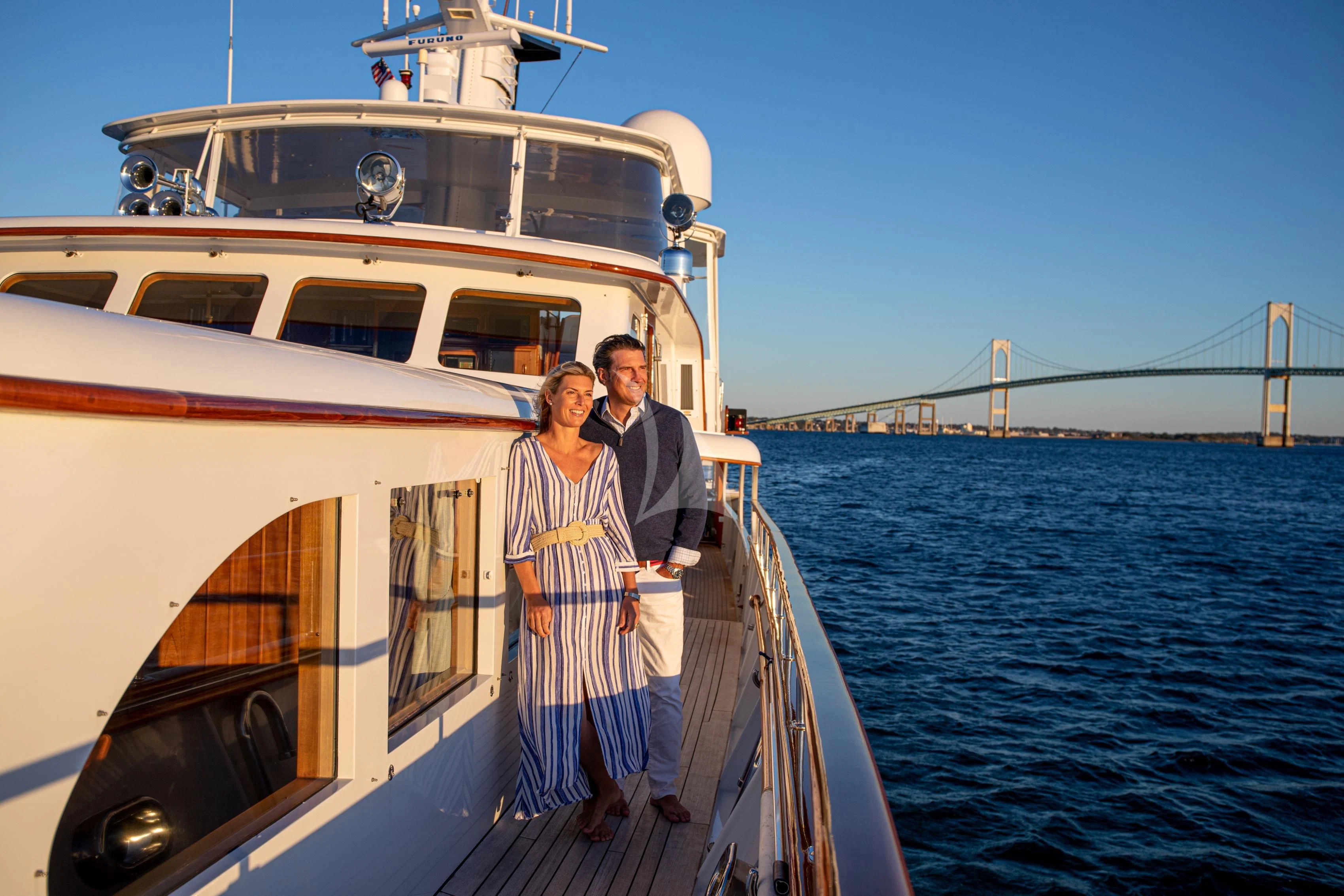 a man and woman standing on a boat in the water aboard MARYBELLE Yacht for Sale