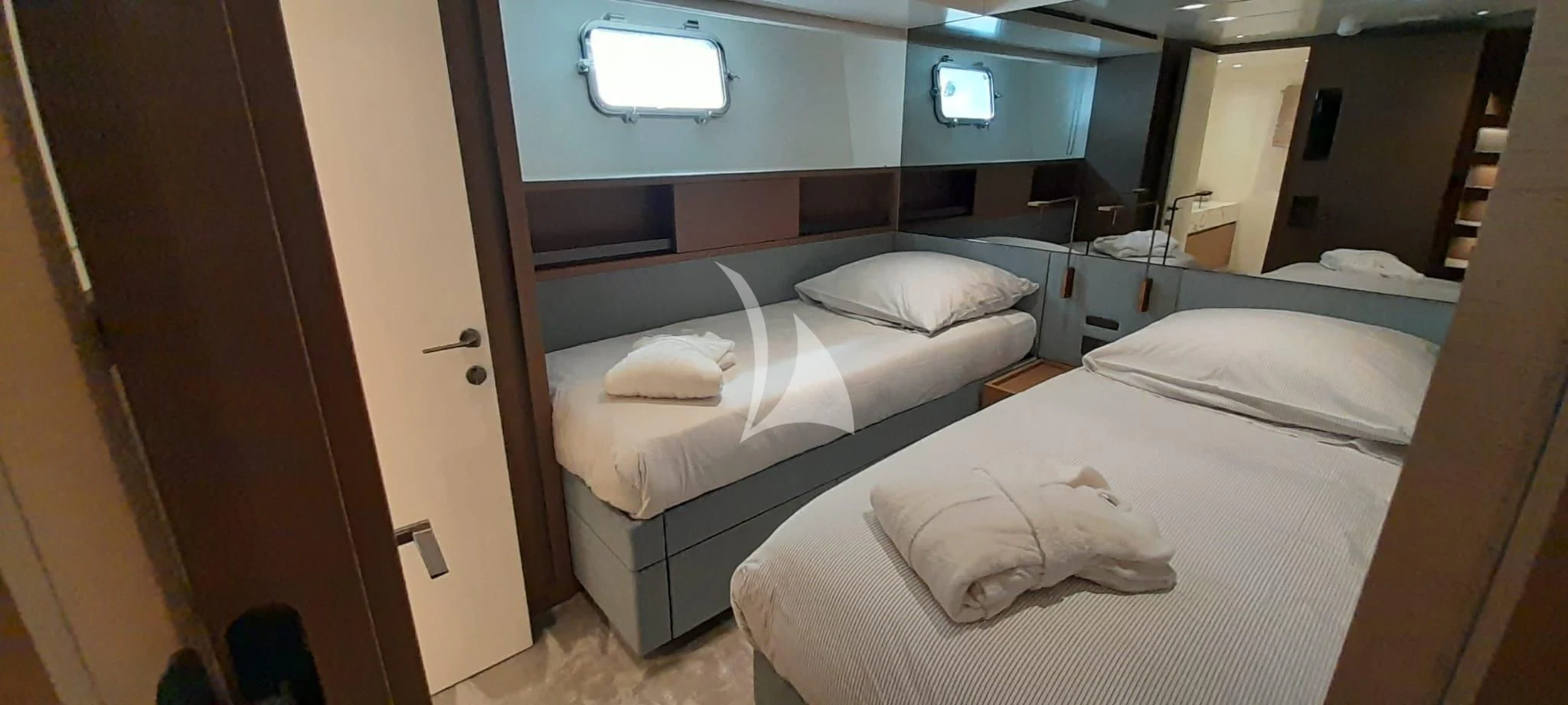 a room with beds and a television aboard SSL Yacht for Sale