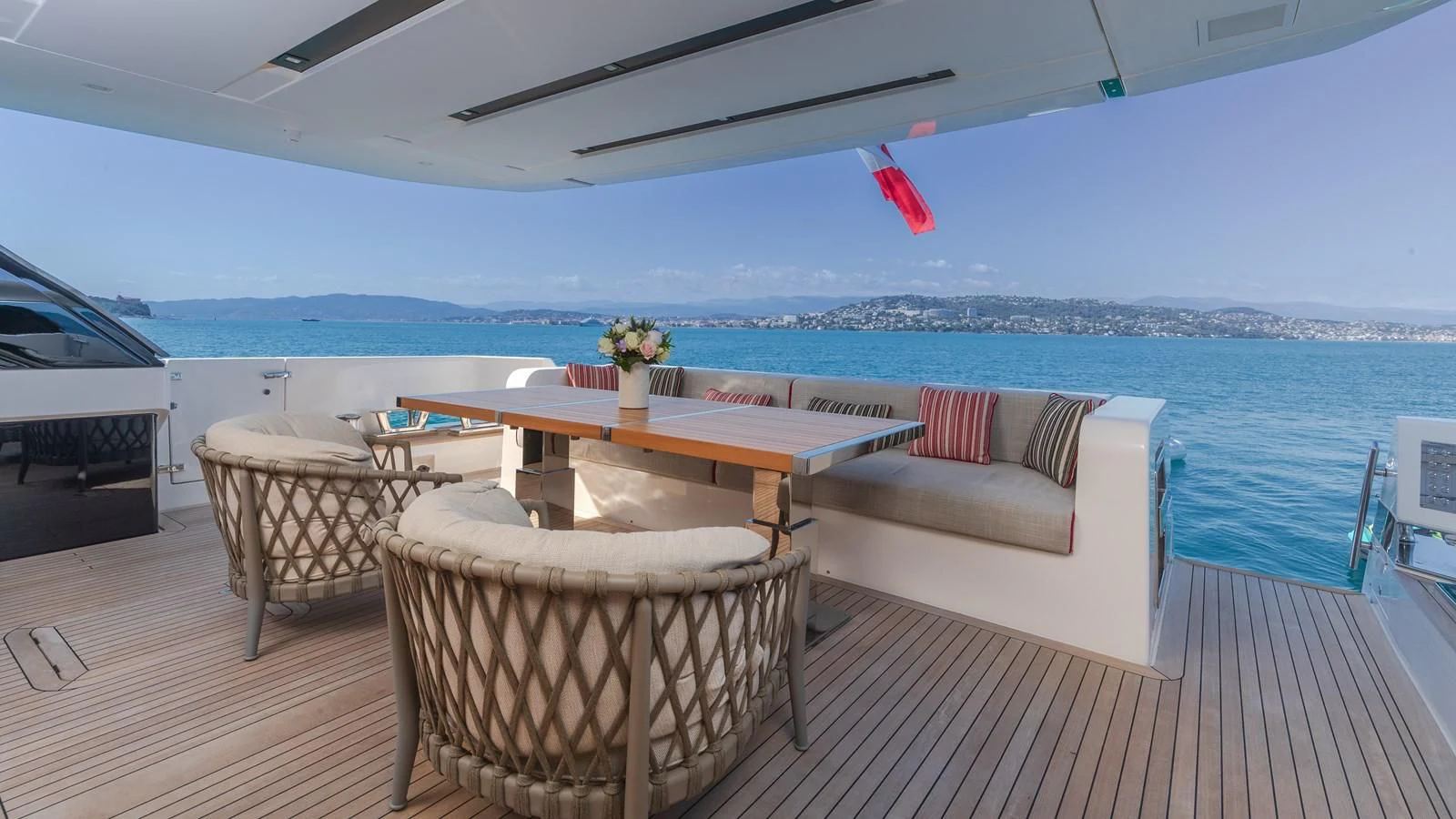 a table and chairs on a deck aboard SSL Yacht for Sale