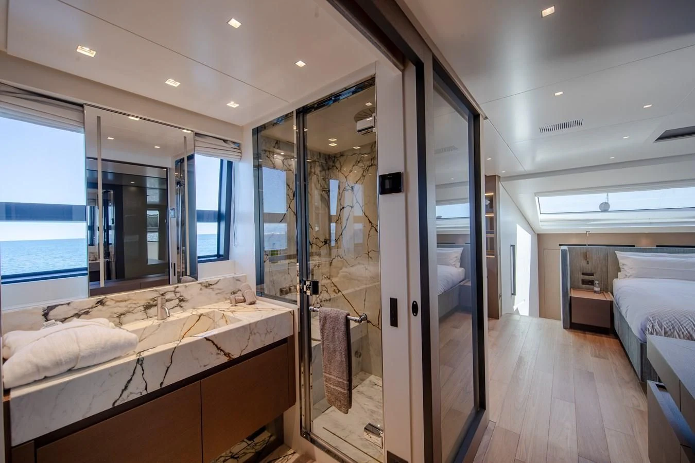 a bedroom with a glass door aboard SSL Yacht for Sale
