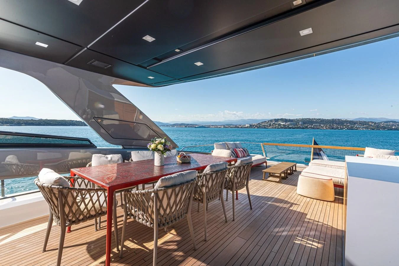 a deck with a table and chairs on it aboard SSL Yacht for Sale