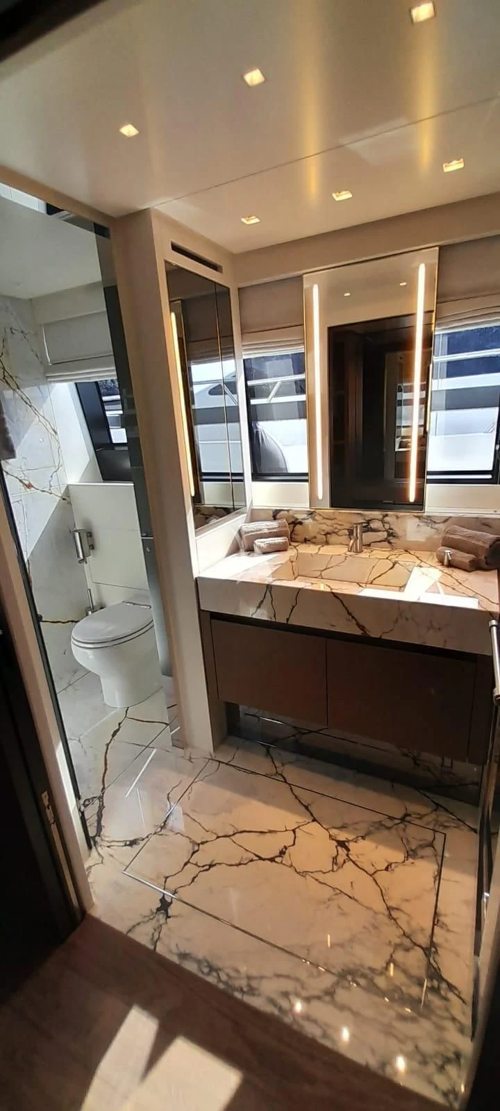 a bathroom with a large marble floor aboard SSL Yacht for Sale
