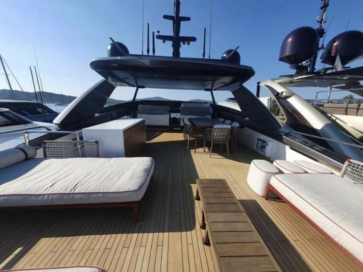 a black plane on a wooden deck aboard SSL Yacht for Sale