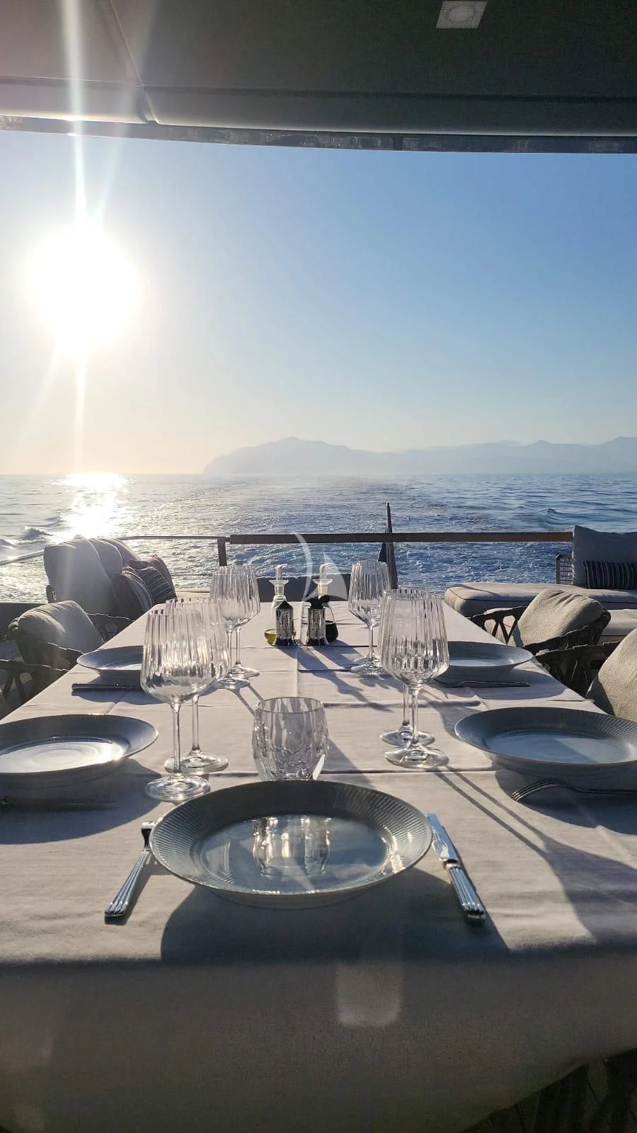 a table with plates and glasses on it aboard SSL Yacht for Sale