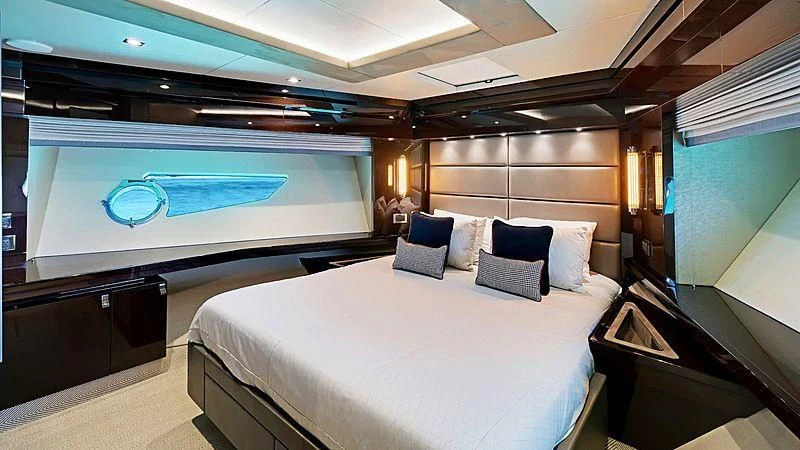 a room with a bed and a large screen aboard SYNERGY Yacht for Sale