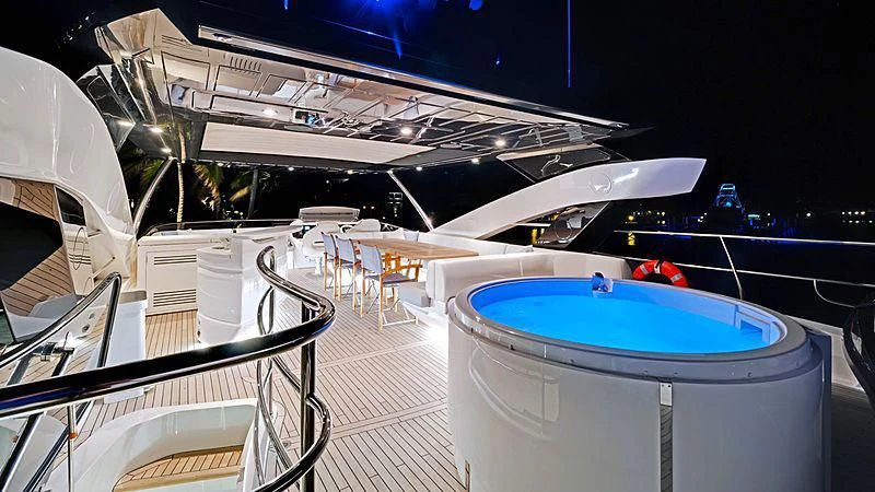 a deck with a pool and a deck with a boat on it aboard SYNERGY Yacht for Sale