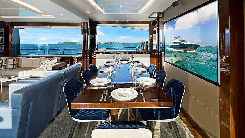 a dining room with a large window aboard SYNERGY Yacht for Sale