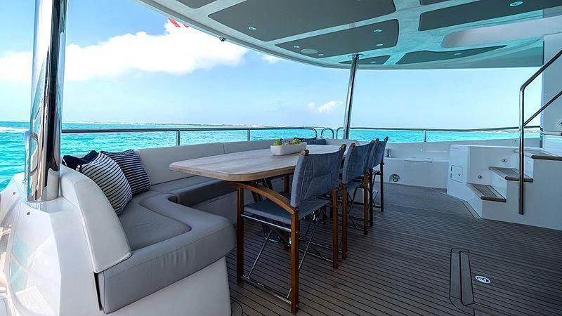 a table and chairs on a deck aboard SYNERGY Yacht for Sale