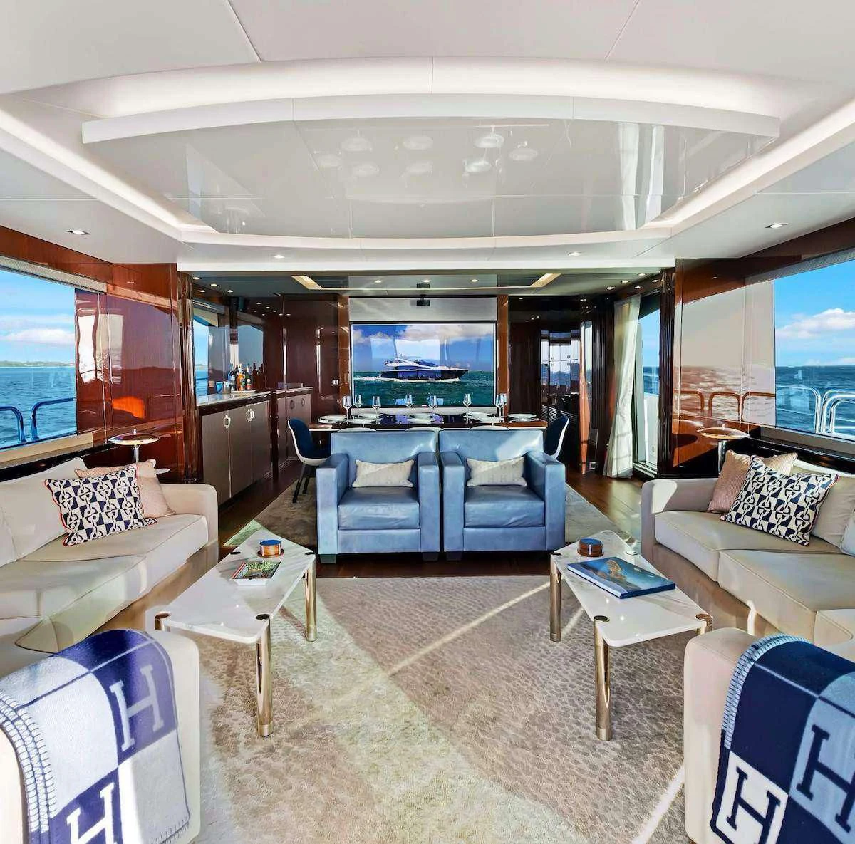 a living room with a large table and chairs aboard SYNERGY Yacht for Sale