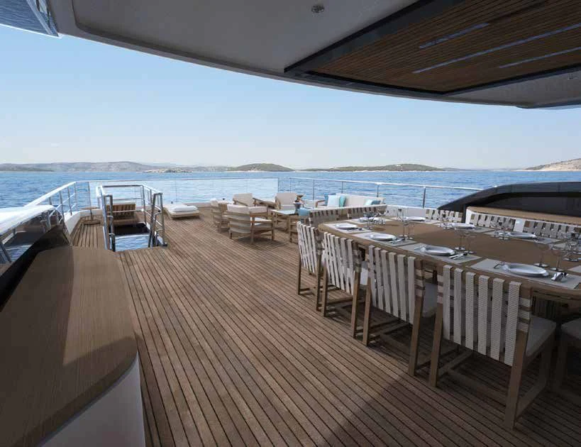 a deck with tables and chairs on it aboard ENZO Yacht for Sale