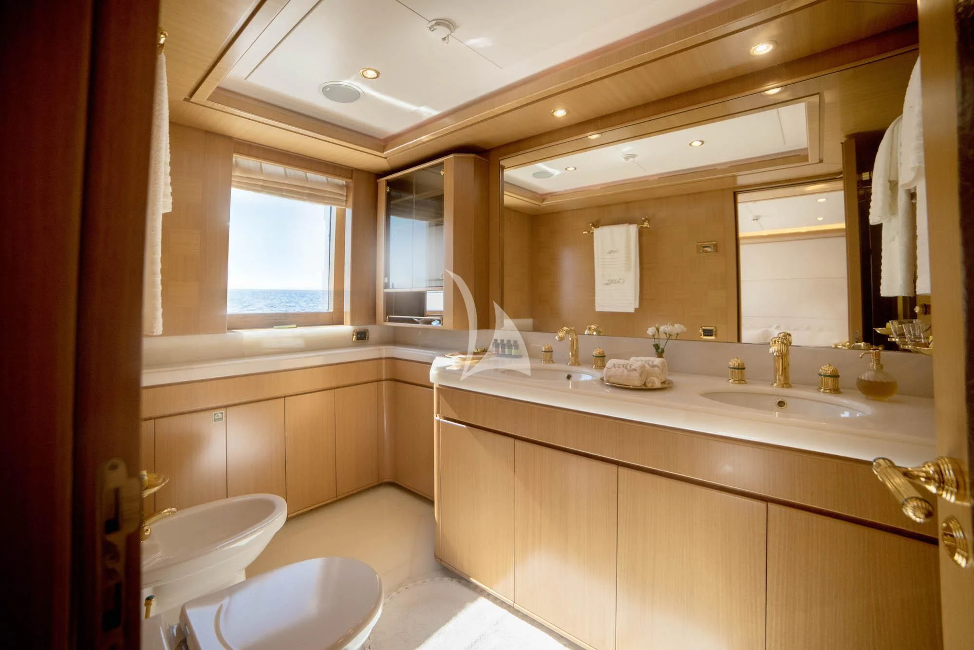 a bathroom with a large mirror aboard OASIS Yacht for Sale