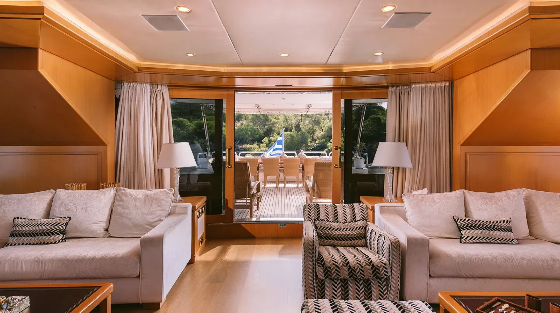 a living room with a couch and a table aboard OASIS Yacht for Sale