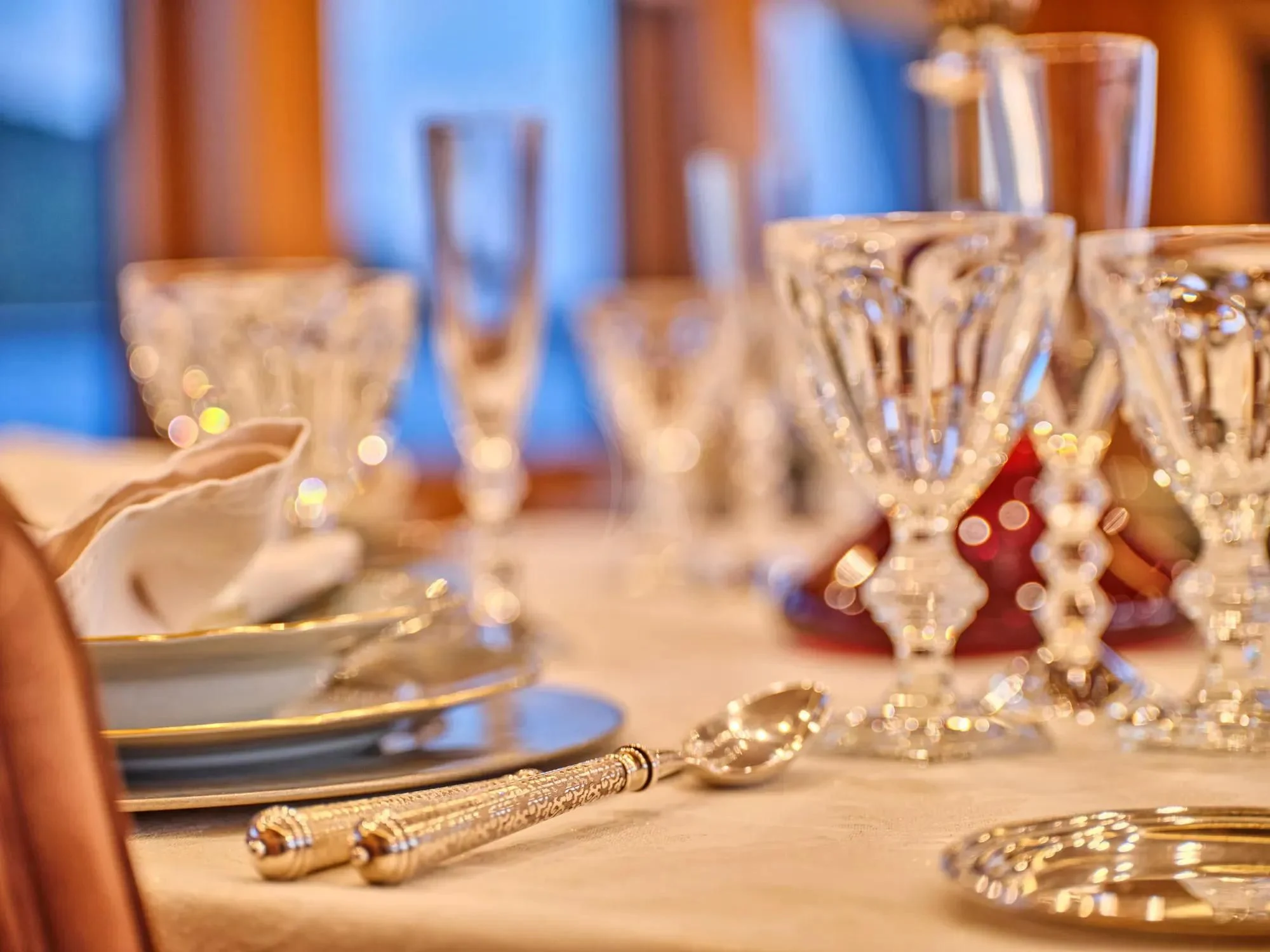 a table with plates and glasses aboard OASIS Yacht for Sale