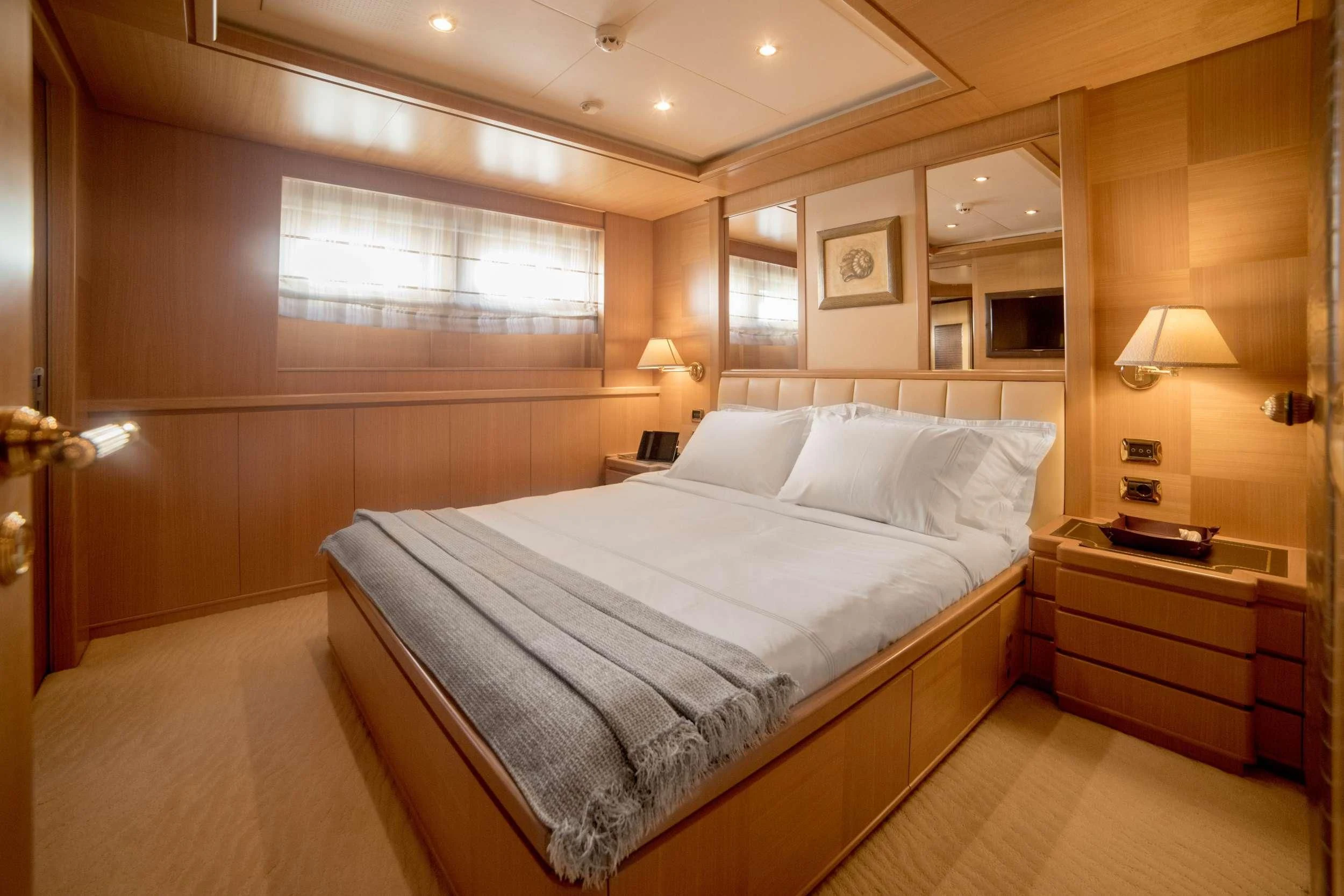 a large bed in a hotel room aboard OASIS Yacht for Sale