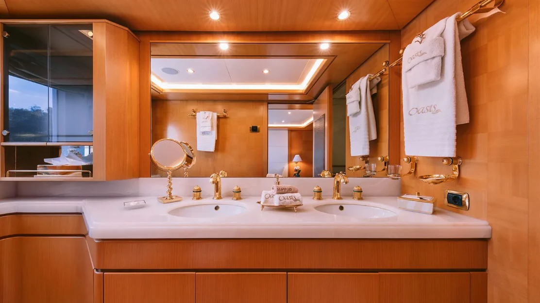 a bathroom with a large mirror aboard OASIS Yacht for Sale